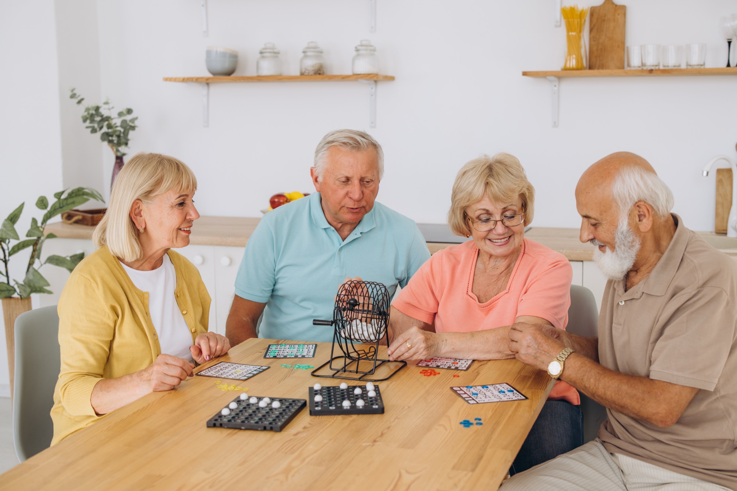 Residents round a table over a game
