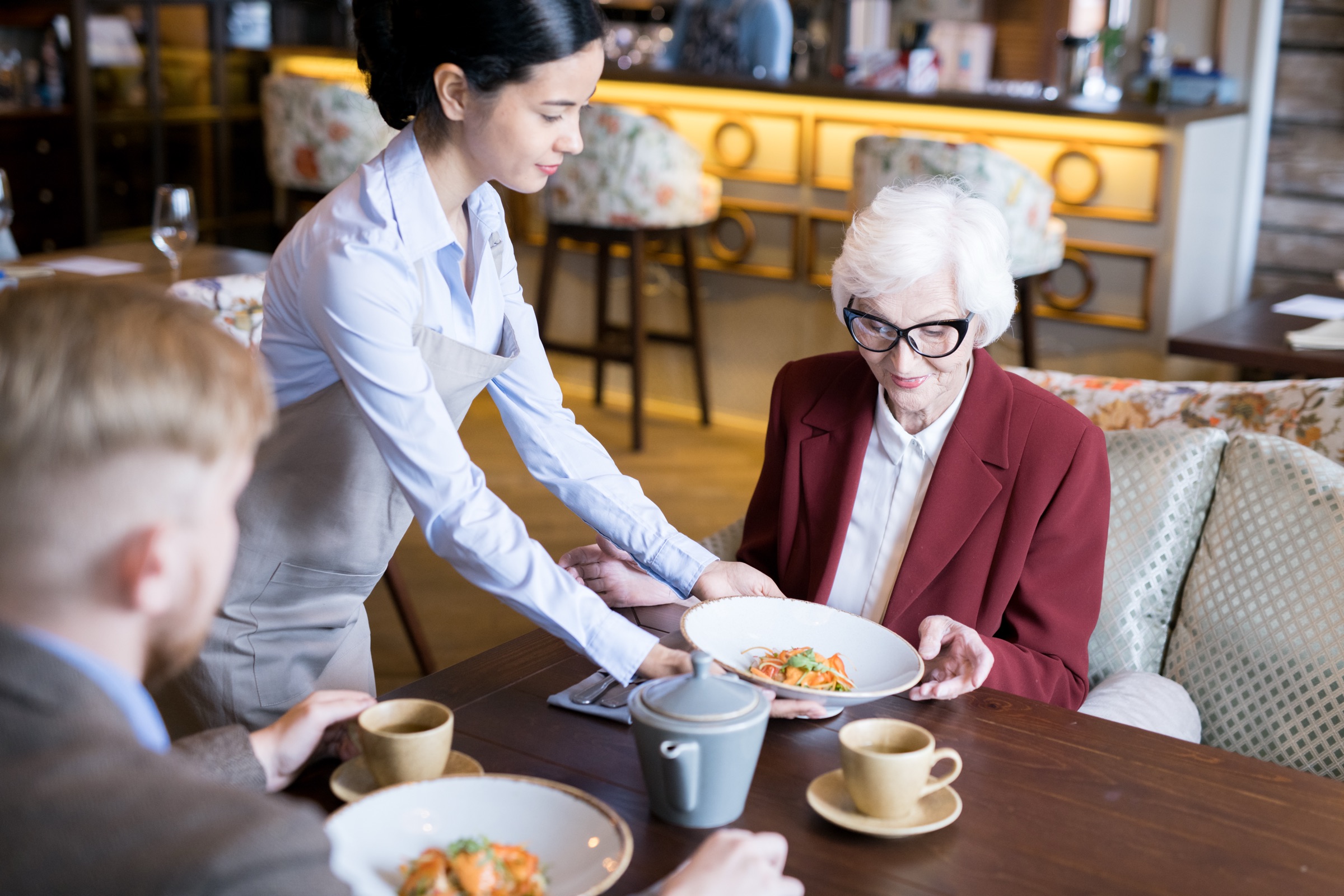 A plate carried to a resident at the table